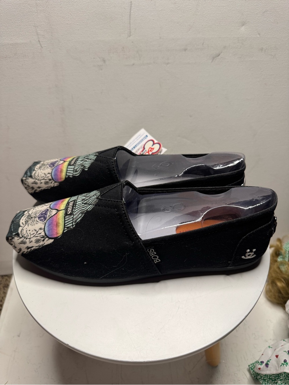 BOBS from Skechers Black Slip-On Flats with Rainbow Skull Accent